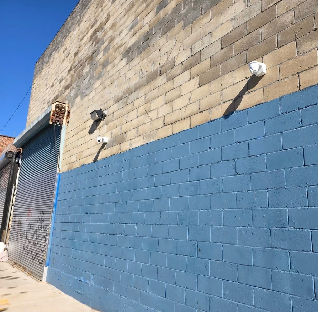 Two security cameras installed on a small commercial building exterior